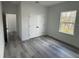 Bedroom with closet, gray floors and a window with a backyard view at 13566 Sw 43Rd Cir, Ocala, FL 34473