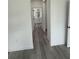 A hallway leading to a bright bathroom, with light gray flooring and white walls at 13566 Sw 43Rd Cir, Ocala, FL 34473