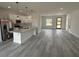 This bright kitchen features white cabinets, a stainless steel refrigerator, pendant lighting, and a breakfast bar at 13566 Sw 43Rd Cir, Ocala, FL 34473