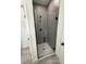 A modern shower with a glass door and gray tiling at 13566 Sw 43Rd Cir, Ocala, FL 34473