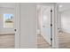 Bright bedroom featuring a large window, light gray flooring, and an attached bathroom, perfect for a modern living space at 13592 Sw 43Rd Cir, Ocala, FL 34473