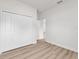 A simple, modern bedroom with wood floors, white walls, and a double door closet for a clean, minimalist look at 13592 Sw 43Rd Cir, Ocala, FL 34473