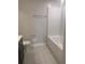 Clean, minimalist bathroom featuring a tub, toilet, and sleek fixtures at 137 Willow Dr, Kissimmee, FL 34759