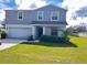 Charming two-story home with a well-manicured lawn and attached two car garage at 137 Willow Dr, Kissimmee, FL 34759