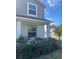 Close-up view of the home's charming porch with decorative columns and lush landscaping at 137 Willow Dr, Kissimmee, FL 34759
