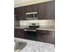 The kitchen boasts modern stainless steel appliances, granite countertops, and dark cabinets at 137 Willow Dr, Kissimmee, FL 34759