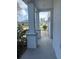 Inviting covered front porch supported by decorative columns and views of neighborhood at 137 Willow Dr, Kissimmee, FL 34759