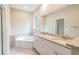 Bathroom with a garden tub, double sink vanity, and granite countertops at 1385 5Th St, Orange City, FL 32763