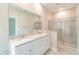 Bathroom with double sink vanity, granite countertops, and a glass-enclosed shower at 1385 5Th St, Orange City, FL 32763