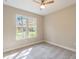 Bright bedroom with large window offering natural light and plush carpeting at 1385 5Th St, Orange City, FL 32763