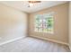 Bedroom with natural light, plush carpet, and a view of the outdoors from the window at 1385 5Th St, Orange City, FL 32763