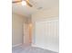 Bedroom with a ceiling fan, neutral walls, plush carpet, and closet storage at 1385 5Th St, Orange City, FL 32763