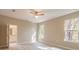 Serene bedroom with neutral carpeting, two windows, and a ceiling fan at 1385 5Th St, Orange City, FL 32763