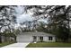 Charming single-story home with a well-manicured lawn and a two-car garage at 1385 5Th St, Orange City, FL 32763
