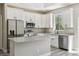 This kitchen features white cabinets, stainless steel appliances, granite countertops and an eat-in island at 1385 5Th St, Orange City, FL 32763