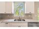 Close-up of a modern kitchen with stainless steel appliances, and a double bowl sink at 1385 5Th St, Orange City, FL 32763