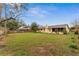 Large backyard featuring a well-maintained lawn, mature trees, privacy fence, and screened-in porch at 1581 Monica Joy Cir, Longwood, FL 32779