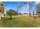 Expansive backyard featuring a well-manicured lawn, mature trees, and privacy fence at 1581 Monica Joy Cir, Longwood, FL 32779