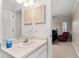 Bathroom showcasing a vanity area connected to the main bedroom and a view of the bedroom decor at 1581 Monica Joy Cir, Longwood, FL 32779