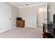 Multi-functional bedroom with a desk and doorway, designed for both work and relaxation in a neutral color palette at 1581 Monica Joy Cir, Longwood, FL 32779