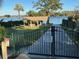 View of the community gate leading to a waterfront area with a picnic shelter and lake access at 1581 Monica Joy Cir, Longwood, FL 32779