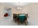 Traditional dining room with a chandelier, wood furniture, and a view to the living room at 1581 Monica Joy Cir, Longwood, FL 32779