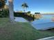 A concrete ramp leading to a wooden dock on the lake, with a covered pavilion in the background at 1581 Monica Joy Cir, Longwood, FL 32779