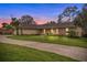 Charming one-story home featuring a large front yard, mature landscaping, and a brick and stucco exterior at 1581 Monica Joy Cir, Longwood, FL 32779