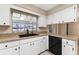 Well-lit kitchen area with granite counters, black appliances, and neutral tile floors at 1581 Monica Joy Cir, Longwood, FL 32779