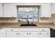 Well-lit kitchen sink area with granite counters and modern black fixtures under a bright window at 1581 Monica Joy Cir, Longwood, FL 32779