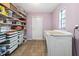 Functional laundry area with shelving, a washing machine, and a window for natural light at 1581 Monica Joy Cir, Longwood, FL 32779
