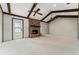 Spacious living room with a brick fireplace, exposed wood beams, and neutral carpet at 1581 Monica Joy Cir, Longwood, FL 32779