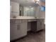 Bathroom with double vanity, quartz countertop, tile flooring, and a large mirror at 17792 Adrift Rd, Winter Garden, FL 34787