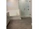 Modern bathroom featuring a glass-enclosed shower, soaking tub, and white subway tile at 17792 Adrift Rd, Winter Garden, FL 34787