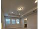 Bedroom with recessed lights, tray ceiling, and many windows for natural light at 17792 Adrift Rd, Winter Garden, FL 34787