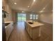 Spacious open-concept kitchen with an island, stainless steel appliances, and hardwood flooring at 17792 Adrift Rd, Winter Garden, FL 34787