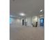 A spacious loft featuring neutral carpeting, staircase, and windows at 17792 Adrift Rd, Winter Garden, FL 34787