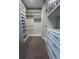 Bright walk-in closet with custom shelving, drawers, carpet flooring, and ample storage space at 17792 Adrift Rd, Winter Garden, FL 34787