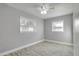 This bedroom features two bright windows, ceiling fan, and hard wood floors at 1797 31St Nw St, Winter Haven, FL 33881