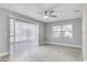 Spacious bedroom with light grey walls, a ceiling fan, and two windows providing ample natural light at 1797 31St Nw St, Winter Haven, FL 33881