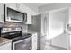 Modern kitchen featuring stainless steel appliances, a mosaic backsplash, and white cabinetry at 1797 31St Nw St, Winter Haven, FL 33881