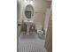 Bathroom featuring black and white tiled floors, pedestal sink, and toilet at 2019 Dixie Belle Dr # 2019O, Orlando, FL 32812