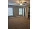 Spacious bedroom featuring large windows, a ceiling fan, and bi-fold closet doors for ample storage at 2019 Dixie Belle Dr # 2019O, Orlando, FL 32812