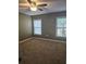 Comfortable bedroom with a ceiling fan, large windows, and neutral walls for a relaxing atmosphere at 2019 Dixie Belle Dr # 2019O, Orlando, FL 32812