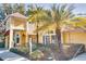Charming clubhouse featuring a yellow exterior, beautiful landscaping, and elegant architectural details at 2019 Dixie Belle Dr # 2019O, Orlando, FL 32812