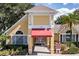 The community clubhouse features a red awning entrance with ample parking and beautiful landscaping at 2019 Dixie Belle Dr # 2019O, Orlando, FL 32812