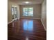 A spacious living room features hardwood floors, neutral walls, and natural light at 2019 Dixie Belle Dr # 2019O, Orlando, FL 32812