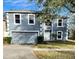 Charming two-story home with a two-car garage and well-maintained landscaping at 2143 Tealwood Cir, Tavares, FL 32778