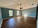 Bright living room featuring hardwood floors, ceiling fan, and lots of natural light at 2143 Tealwood Cir, Tavares, FL 32778