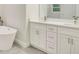 Modern bathroom with double vanity, tub, quartz countertop, and stainless steel fixtures at 2252 Sw 168Th Loop, Ocala, FL 34473